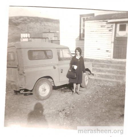 Doreen (Power) Ennis in front of Father Power's jeep 1965